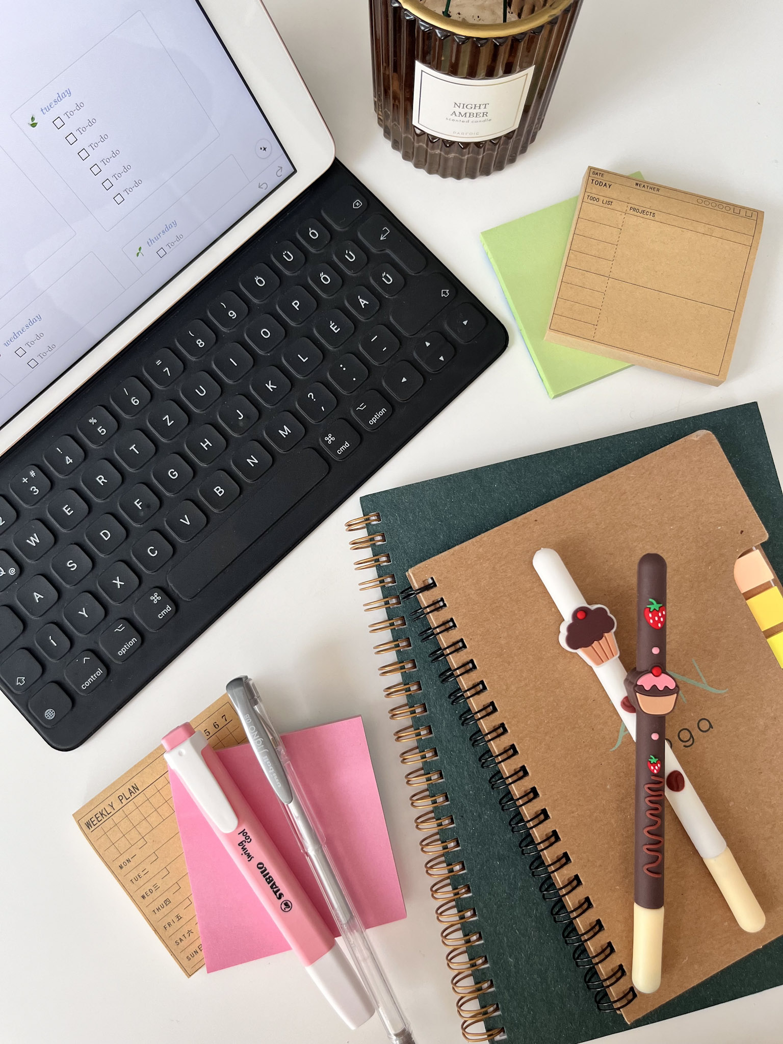 beginner blogger desk setup with notebooks and candle